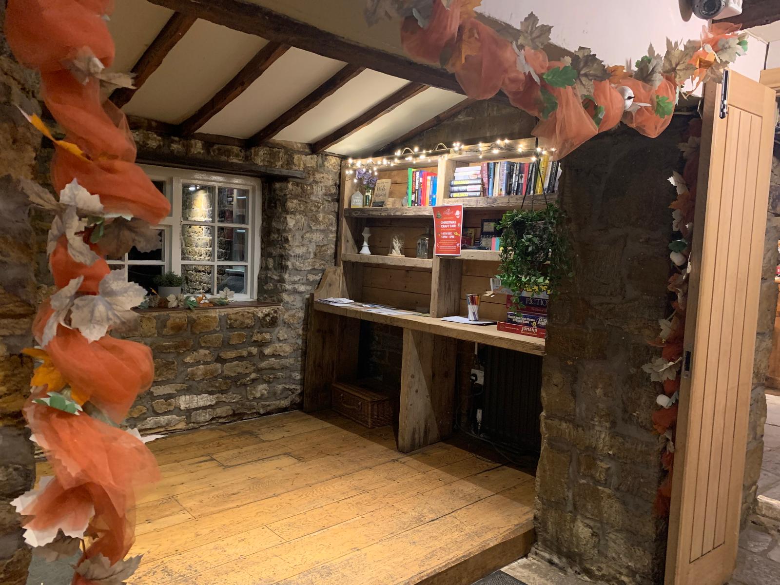 Snug corner with books and board games at The Hollybush Inn